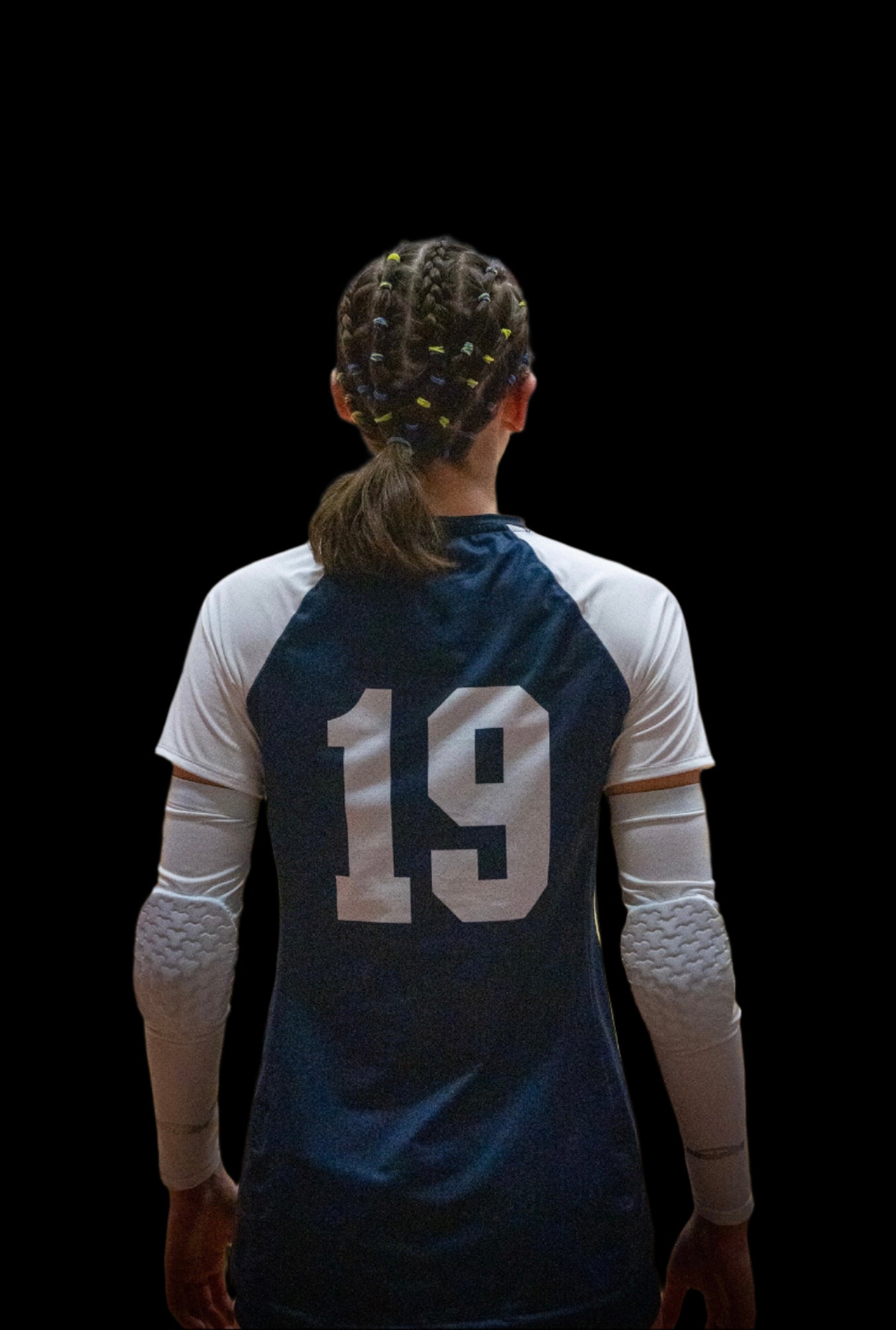 Person wearing a volleyball jersey with the number 19 on a court